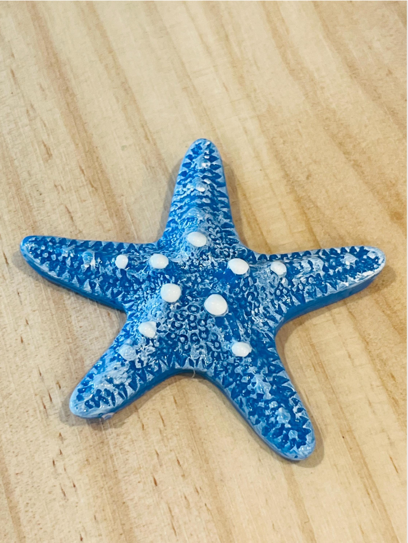 Blue starfish with white spots on a wooden surface, displayed in an app interface.