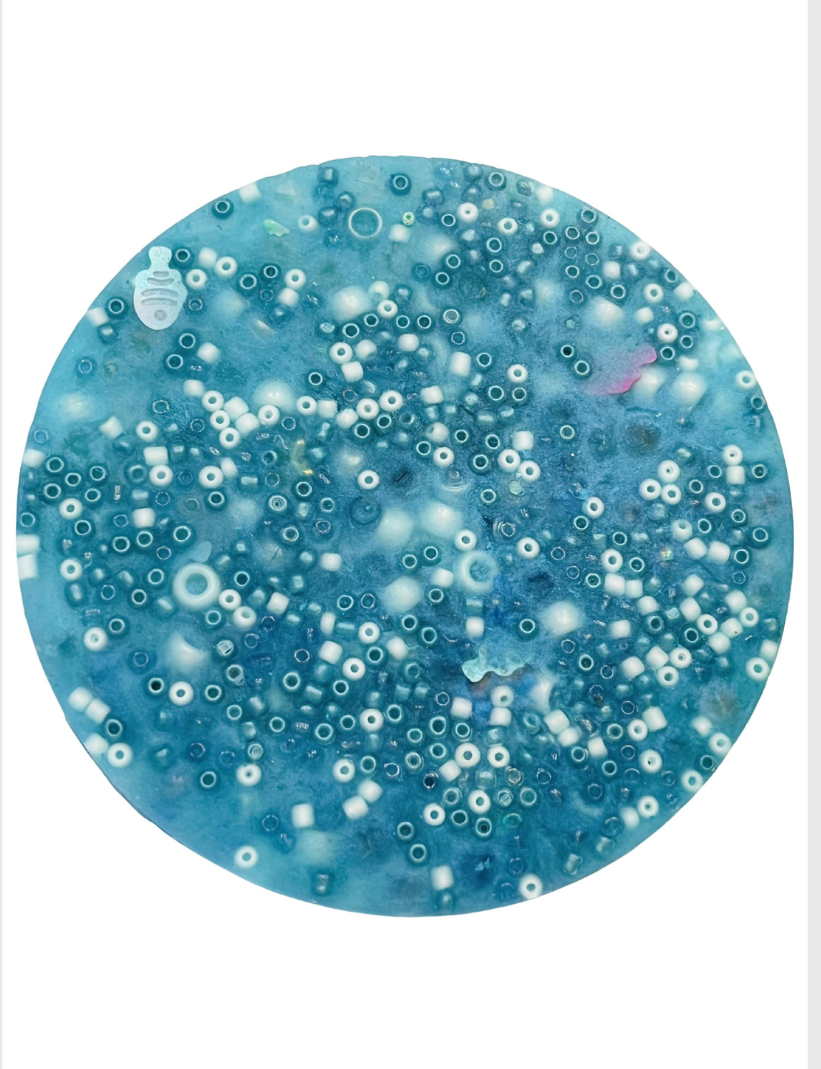 Light blue resin art piece with embedded white beads on a smartphone screen with editing options.